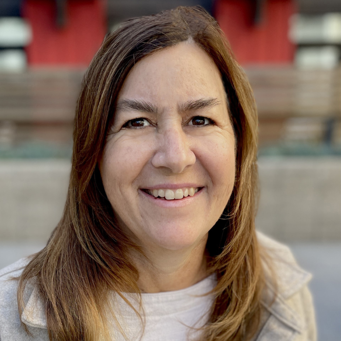 Woman smiling in an outdoor portrait on campus steps.