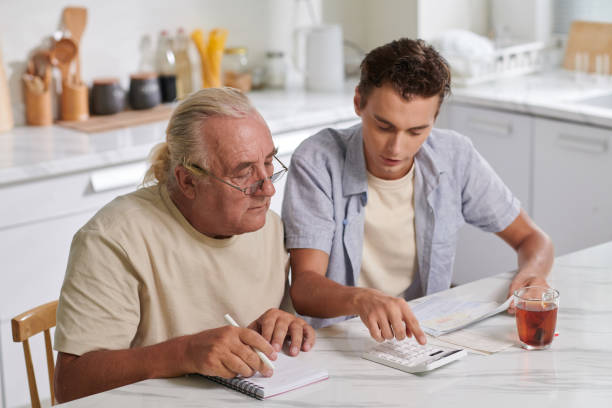 Grandson helping grandfather to calculate expenses